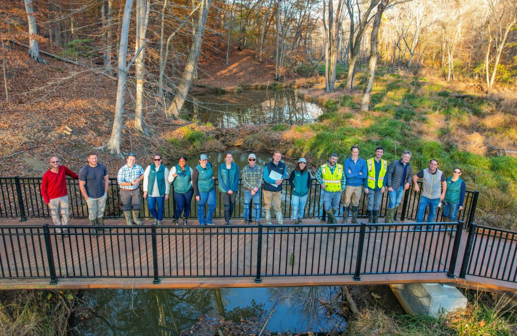 GreenVest Staff on Bridge at Bacon Ridge Branch Stream Restoration Project